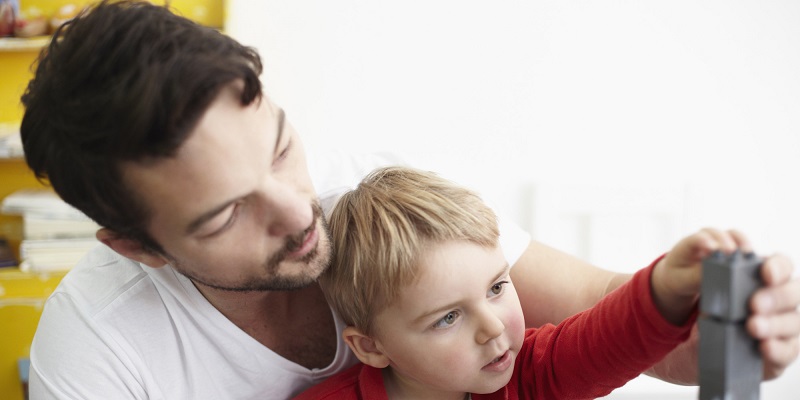 Father and son building with blocks